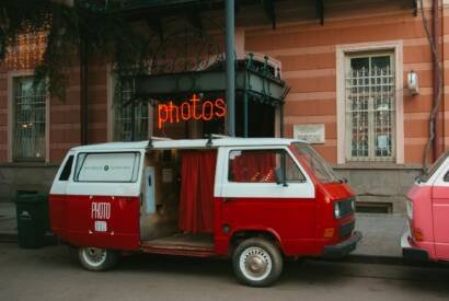 bus redone into a photo boots parked by a building