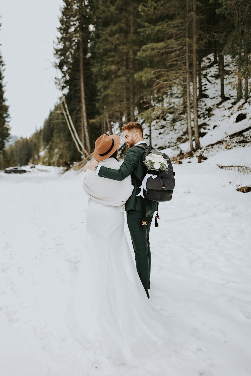 newlyweds together in forest in winter