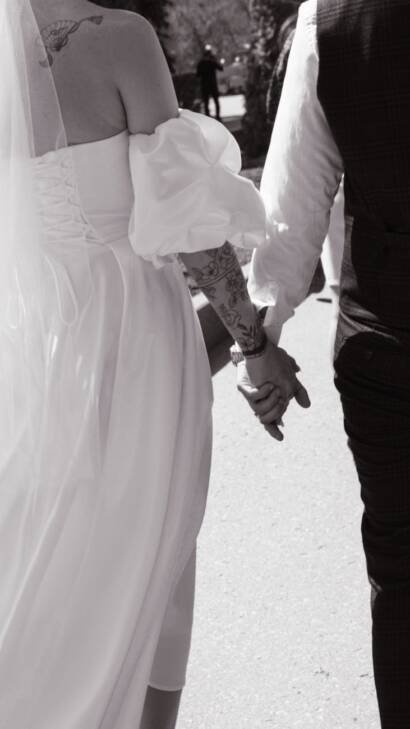 romantic wedding couple holding hands outdoors