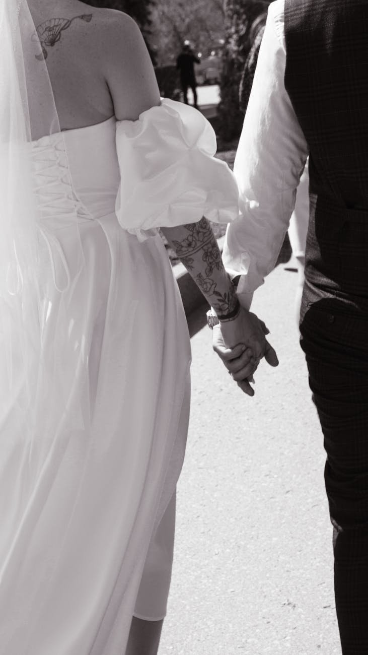 romantic wedding couple holding hands outdoors