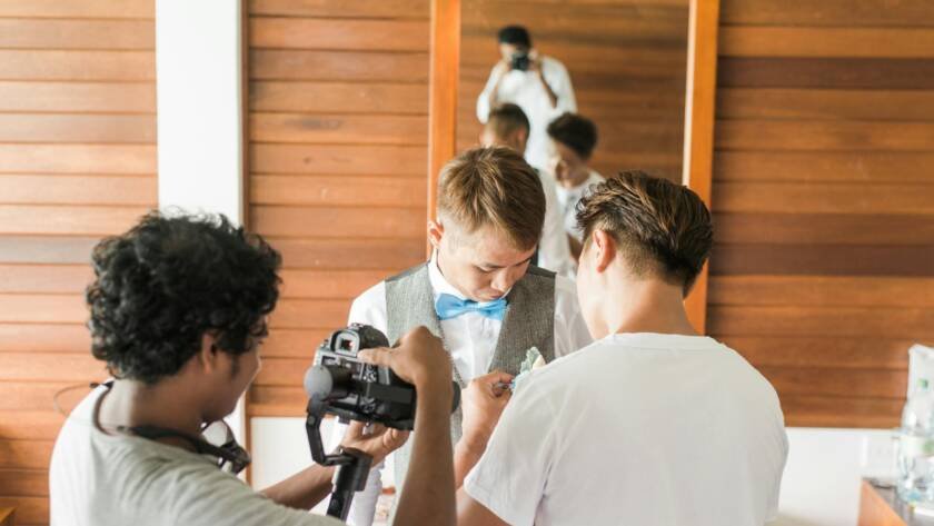man in gray shirt holding camera