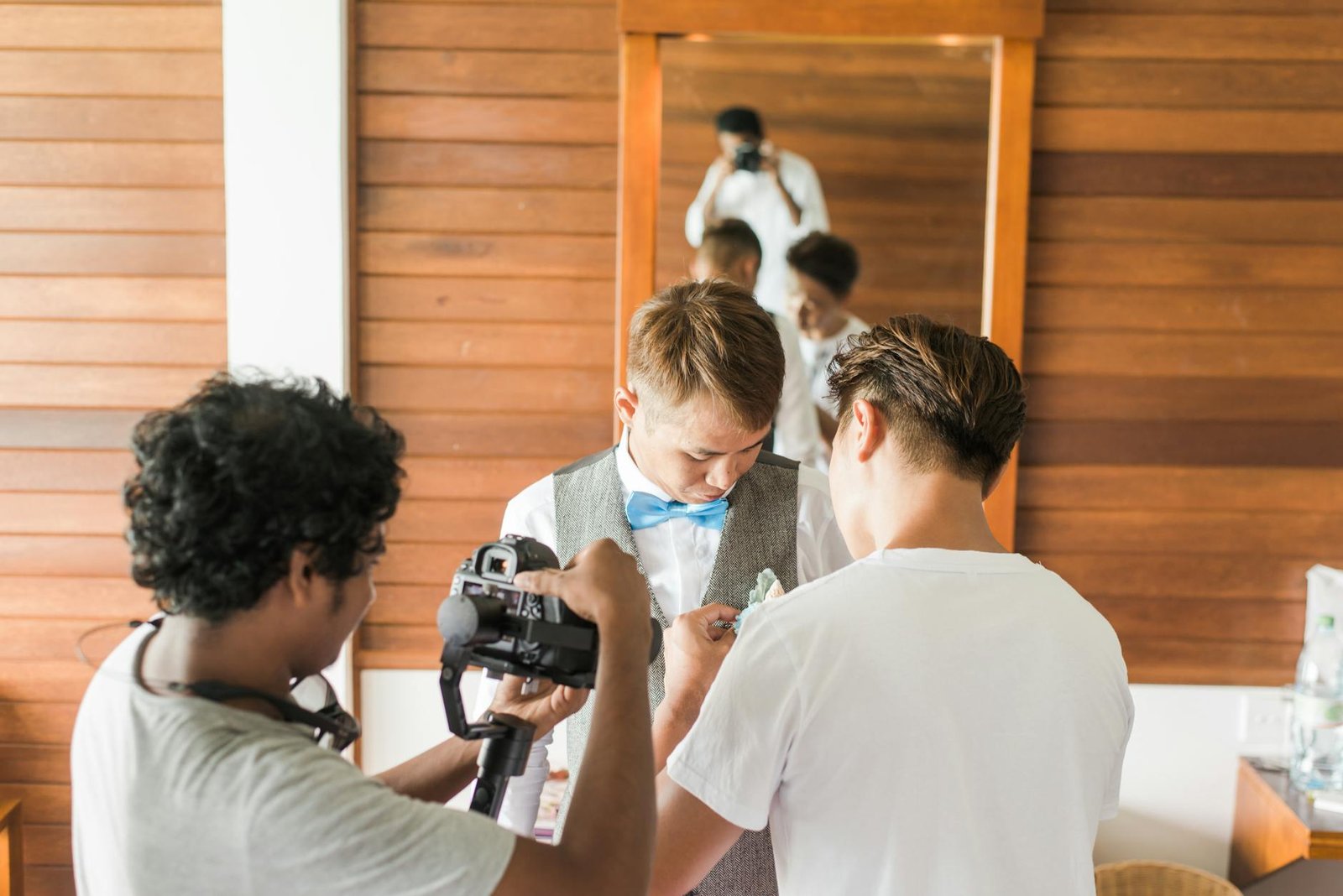 man in gray shirt holding camera