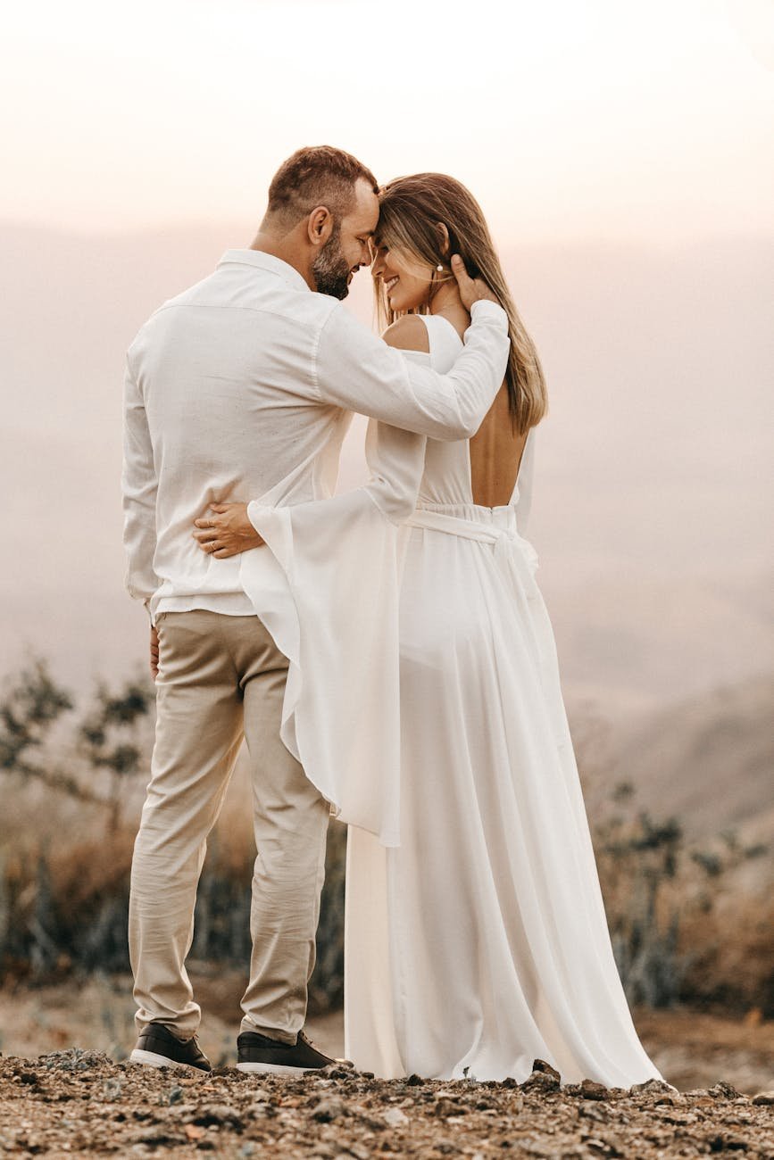 man and woman in white dress and suit