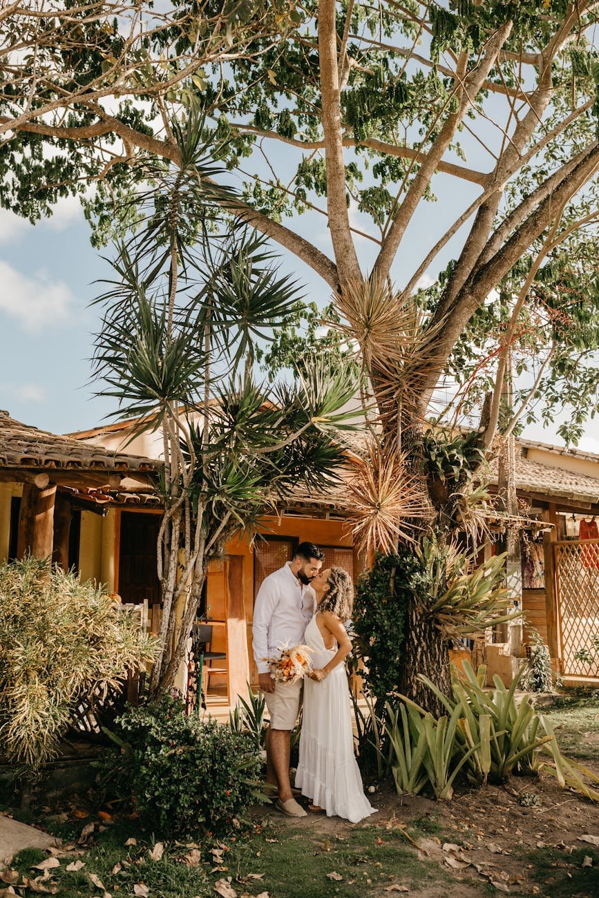 newlyweds kissing under a tree