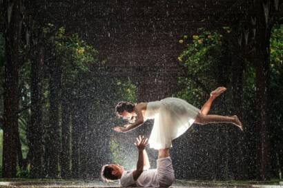 bride and groom doing a photoshoot in the rain