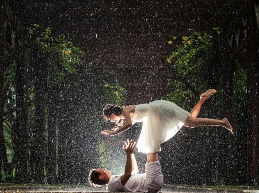 bride and groom doing a photoshoot in the rain