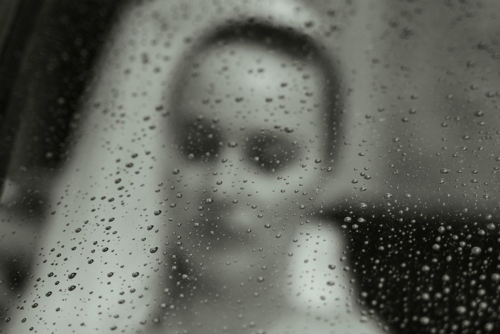 bride behind window with raindrops