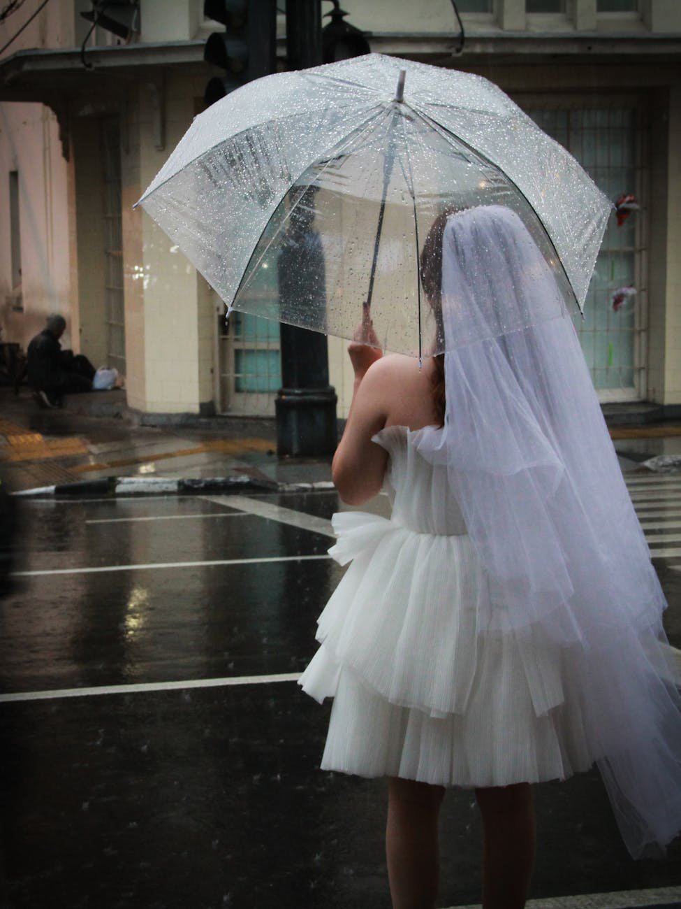 bride in rain with transparent umbrella