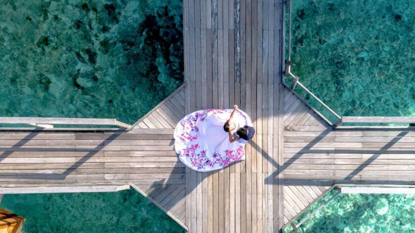 a couple standing on a boardwalk