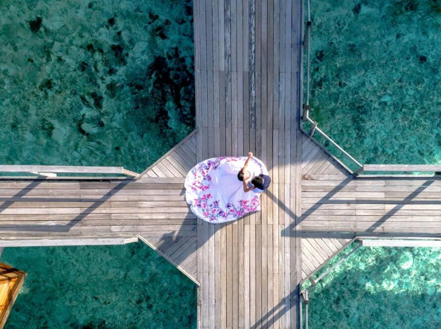 a couple standing on a boardwalk